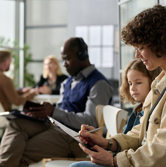 People at immigration office filling out the documents